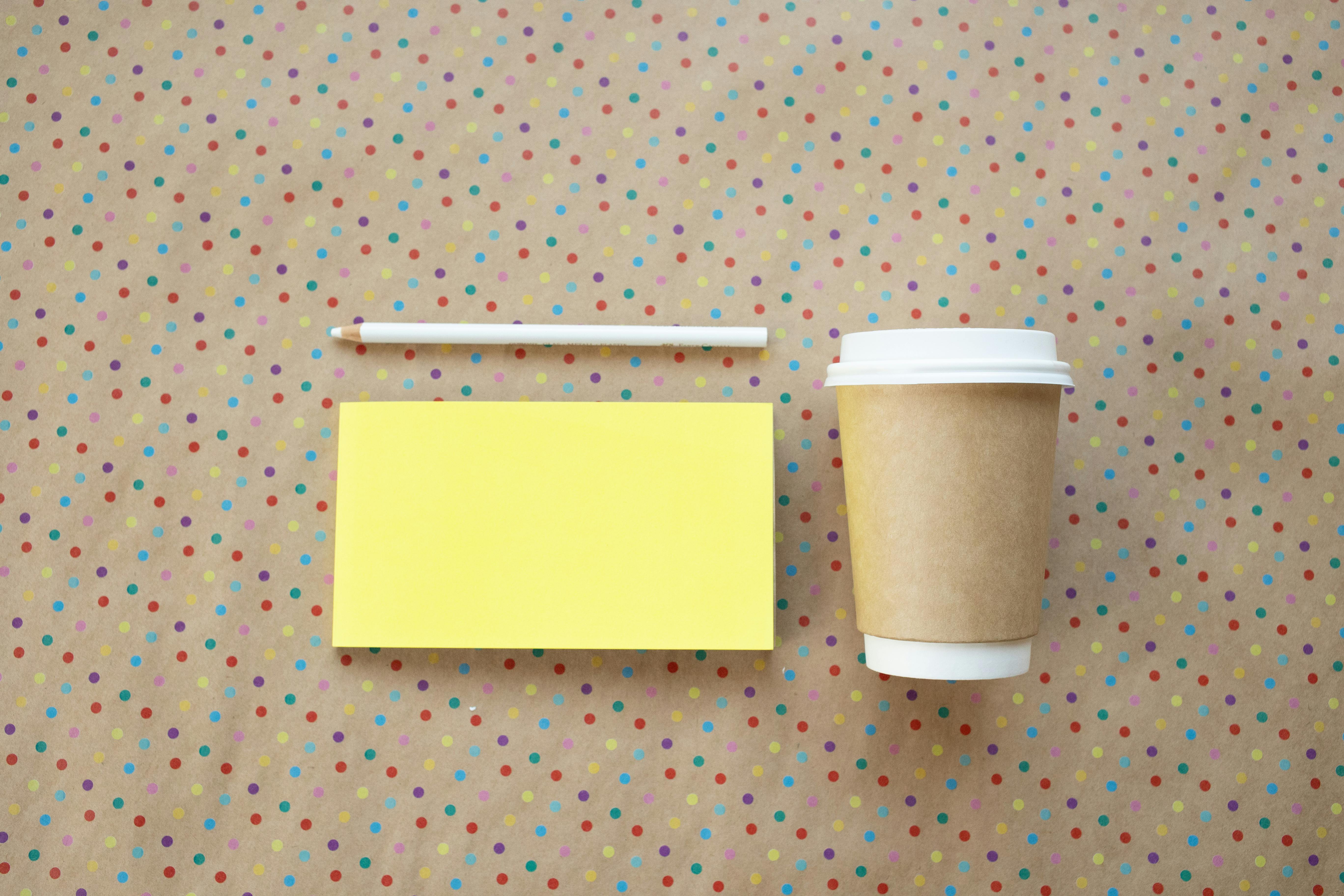 yellow sticky note and a disposable cup