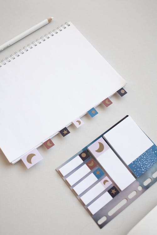 White Notebook and Stationery on a White Surface