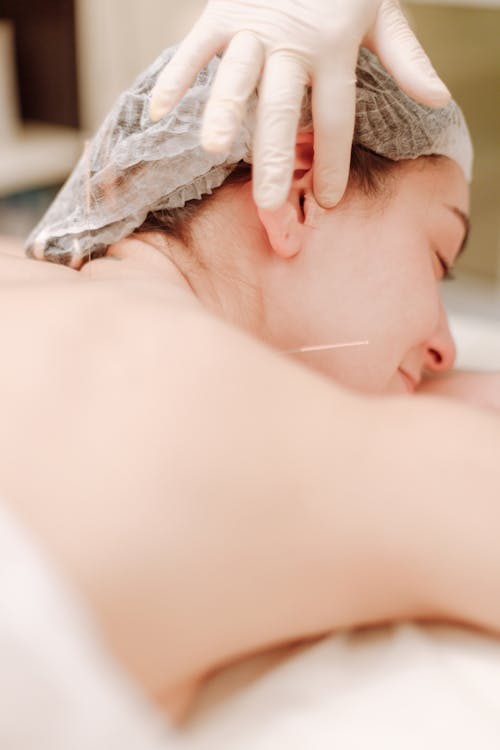 Woman Wearing a Hair Net Lying Down With Eyes Closed