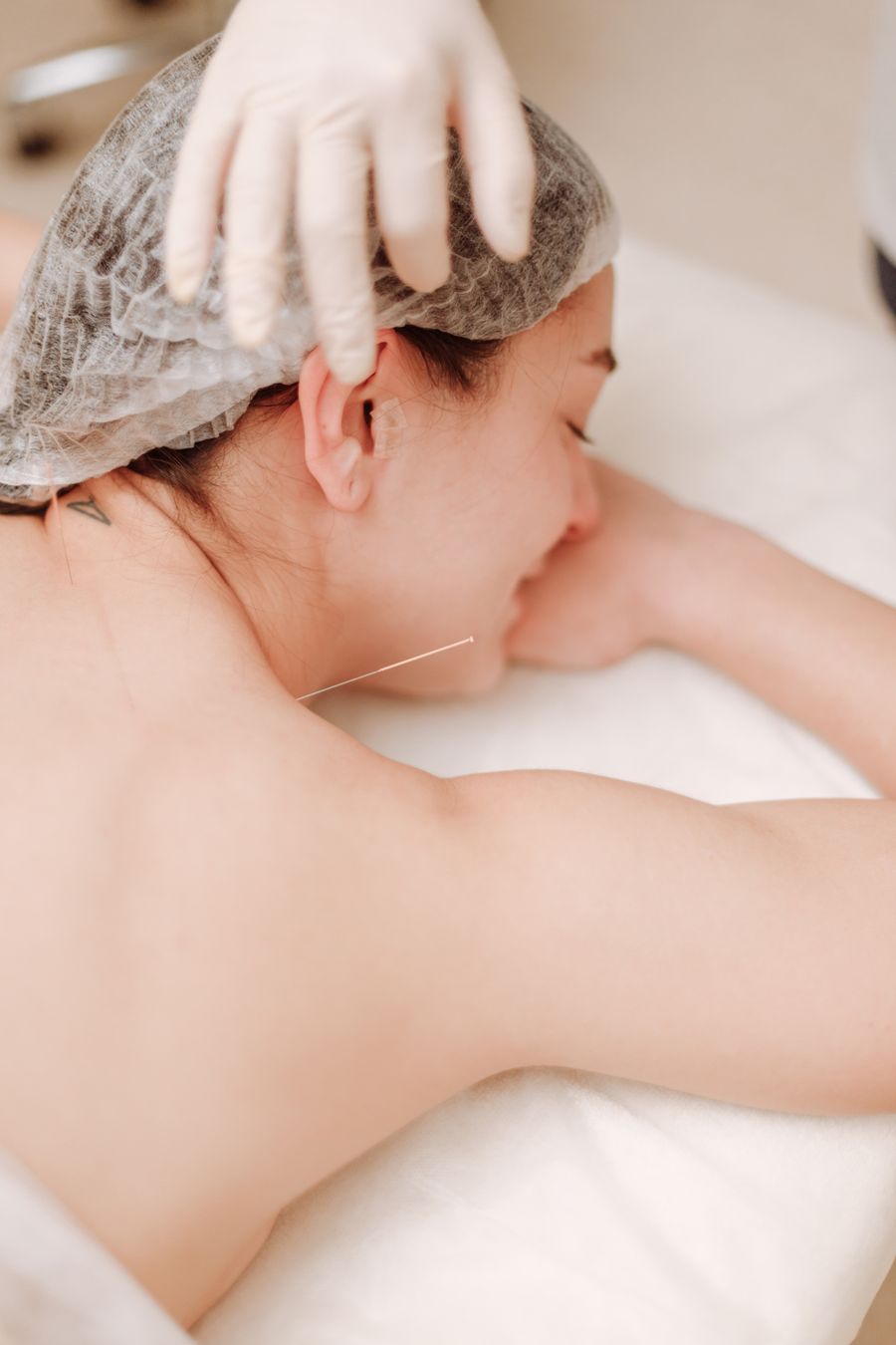 Patient resting face-down with a fine needle placed near the shoulder