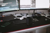 Black Ceramic Mug In Front of a Computer