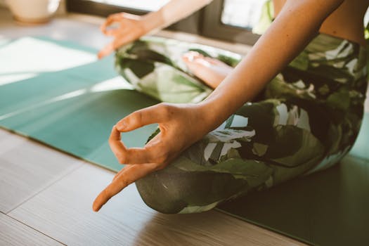 Serene close-up of woman practicing yoga on a mat indoors in natural light.
