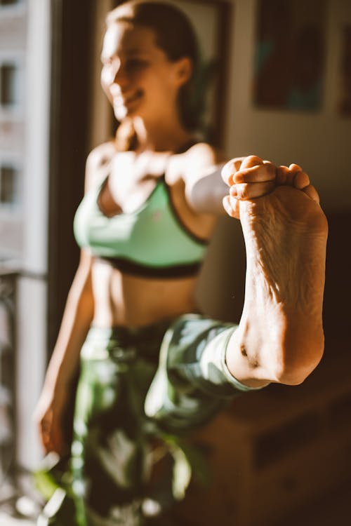 A Woman Doing Yoga Holding Her Foot