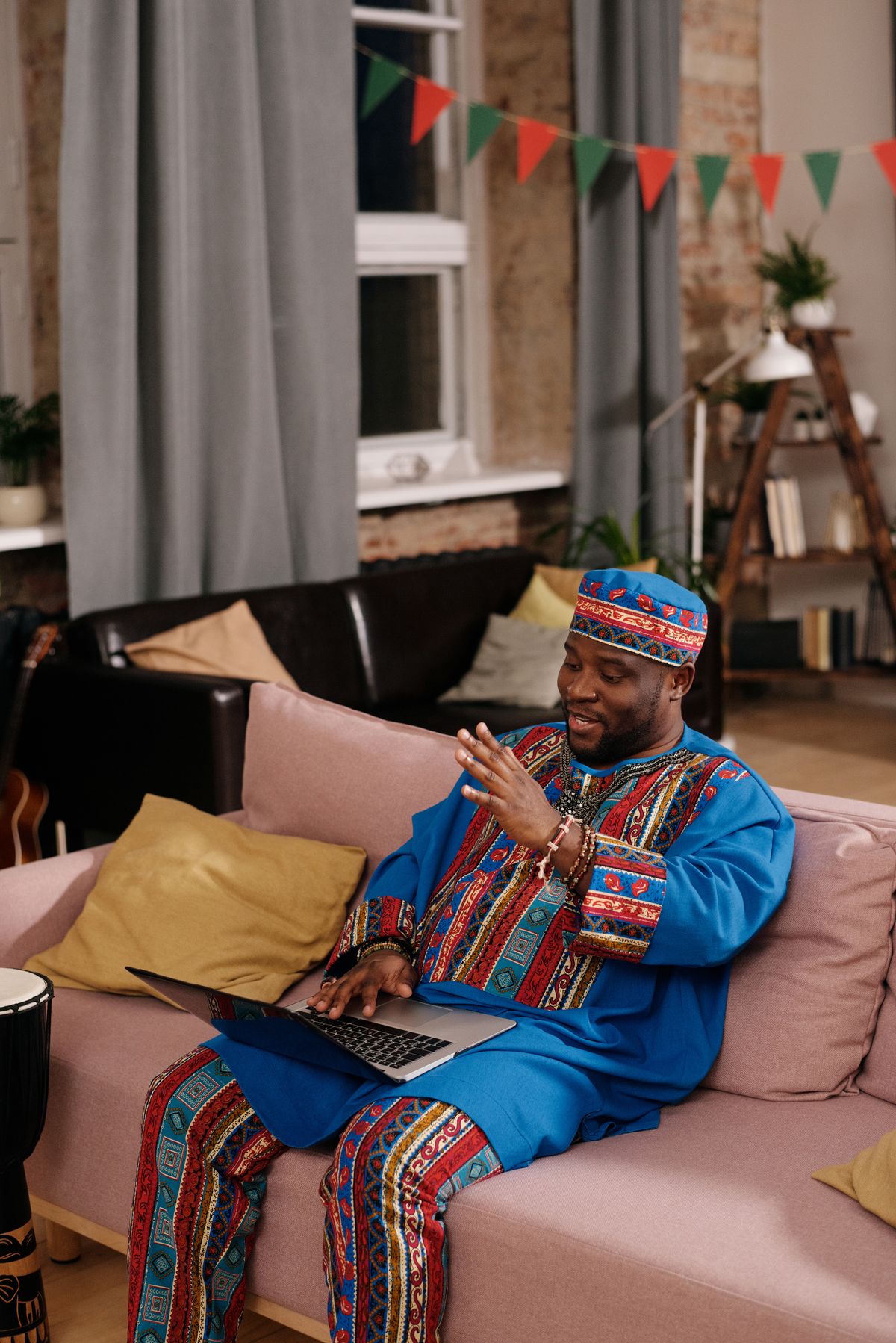 African professional writing an update on a laptop