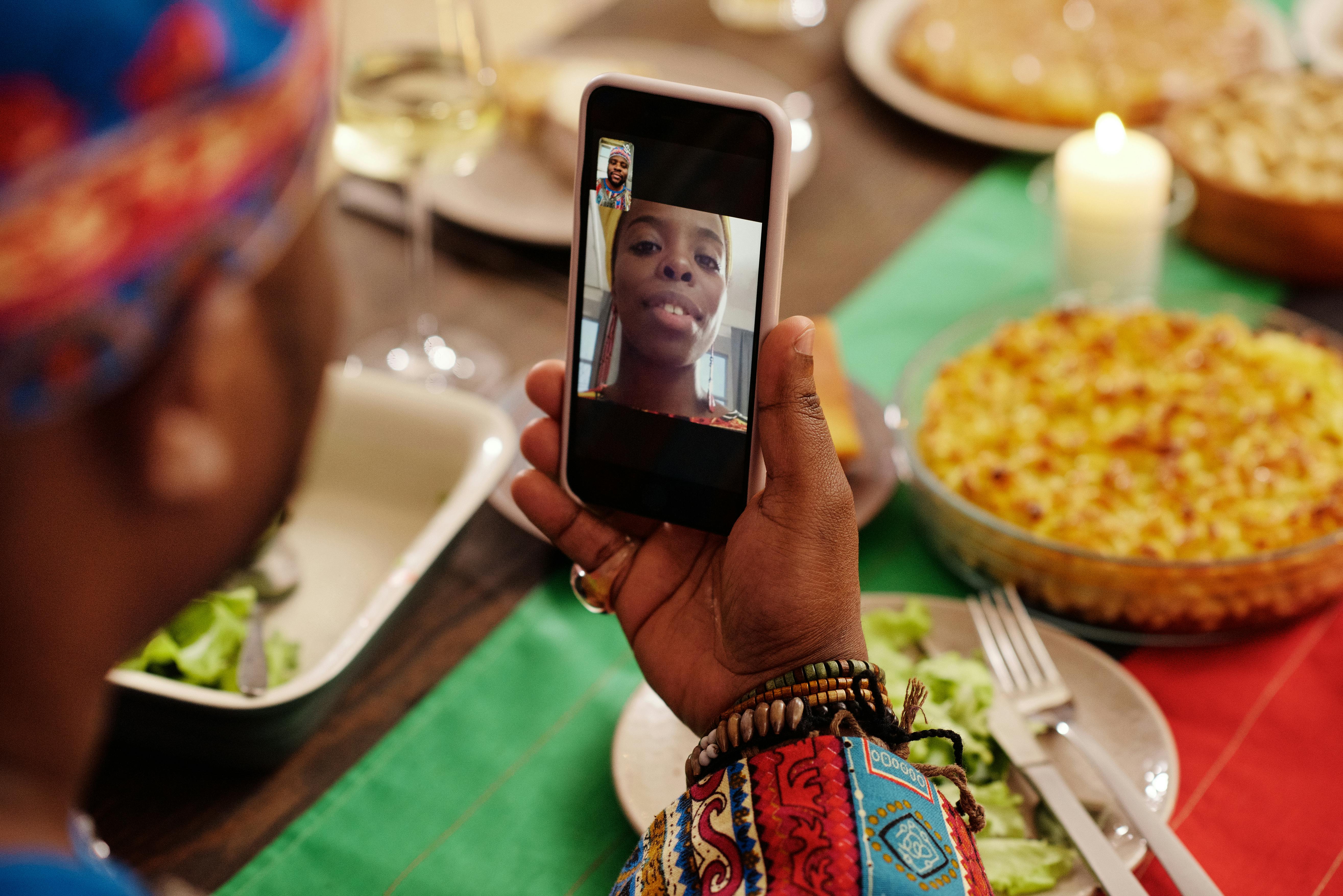 photo of man having a video call on his phone