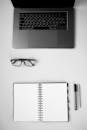 A Laptop and an Eyeglasses Near the Notebook