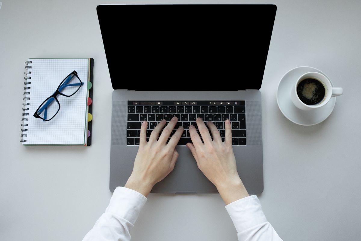 Person typing on a laptop — testing ChatGPT and Gemini side by side