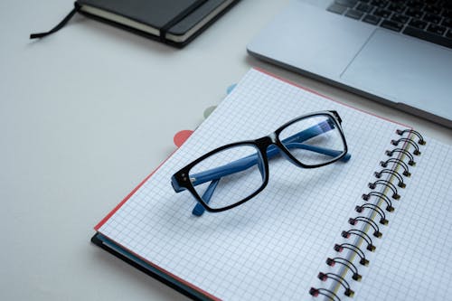 Eyeglasses on Top of a Notebook 