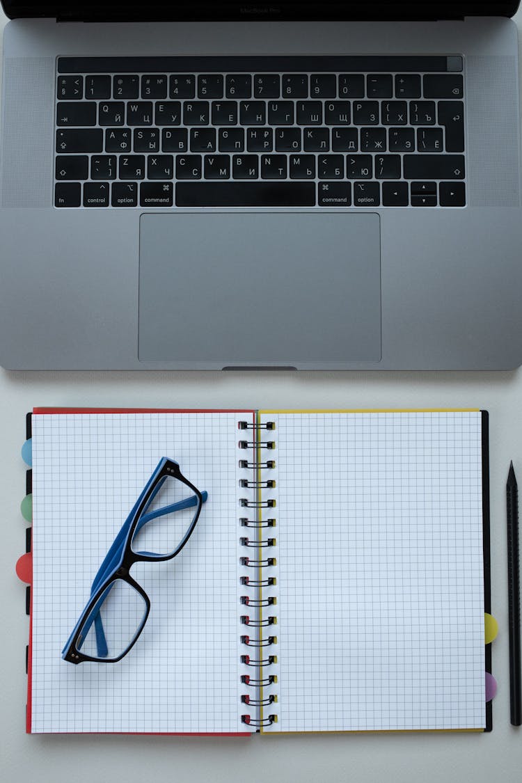 Framed Eyeglasses On A Notebook