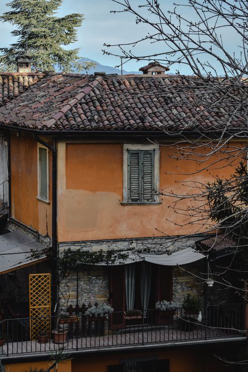 Free A vintage house in Bergamo, Italy, showcasing unique architecture with rustic details and tiled roof. Stock Photo