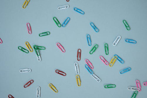 Multi Colored Paper Clips on Blue Surface