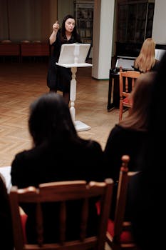 A woman conductor guides musicians in a rehearsal room. Professional and inspiring.