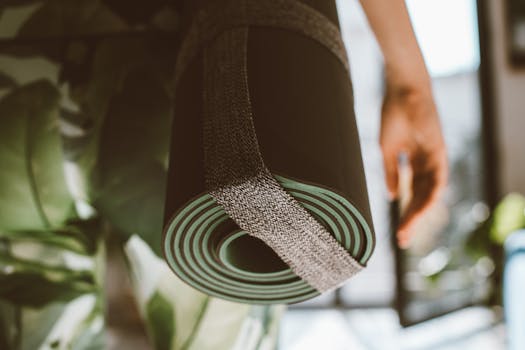 A close-up of a rolled yoga mat with a strap, ideal for fitness imagery.