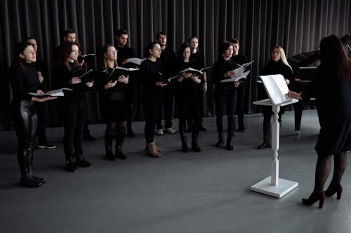 A Choir Wearing Black Clothes Singing Together