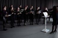 A Choir Wearing Black Clothes Singing Together