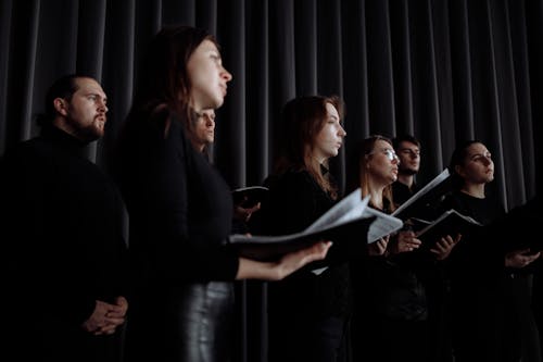 Free Group of Men and Women Singing Together Stock Photo