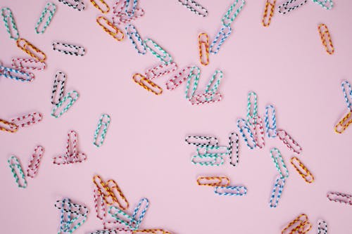 Colorful Paper Clips on Pink Background