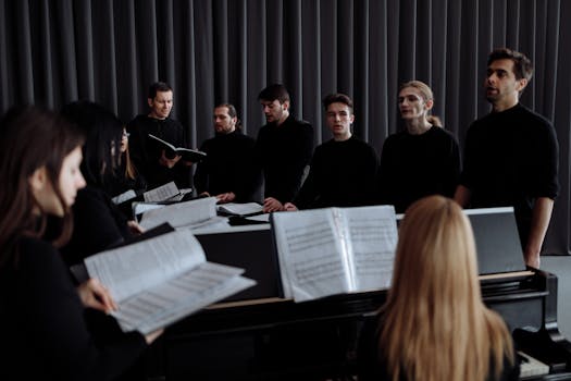 A group of choir members practicing with music sheets in a theater setting.
