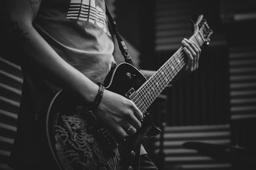 Free Grayscale Photo of Man Playing Electric Guitar Stock Photo