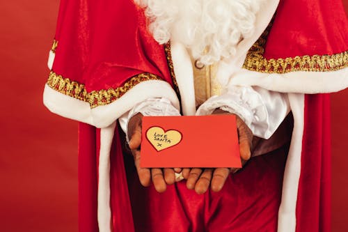 Free Person Wearing Santa Claus Outfit While Holding Christmas Letter Stock Photo