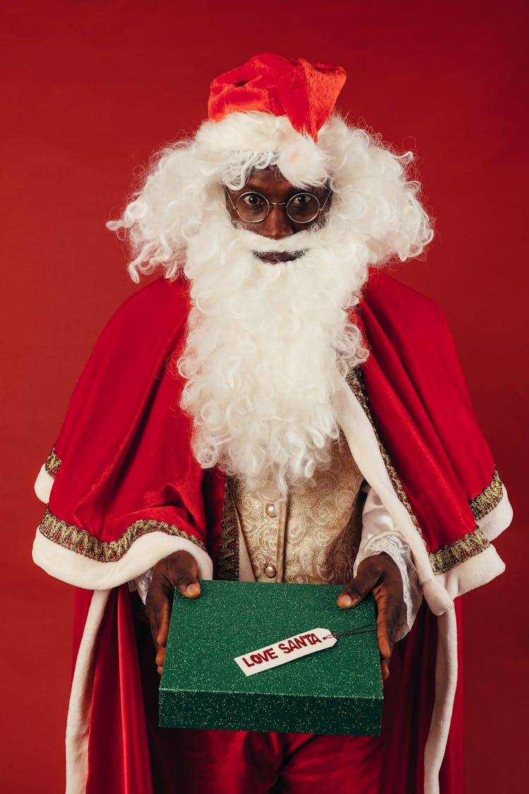 Santa Claus Holding Green Christmas Present