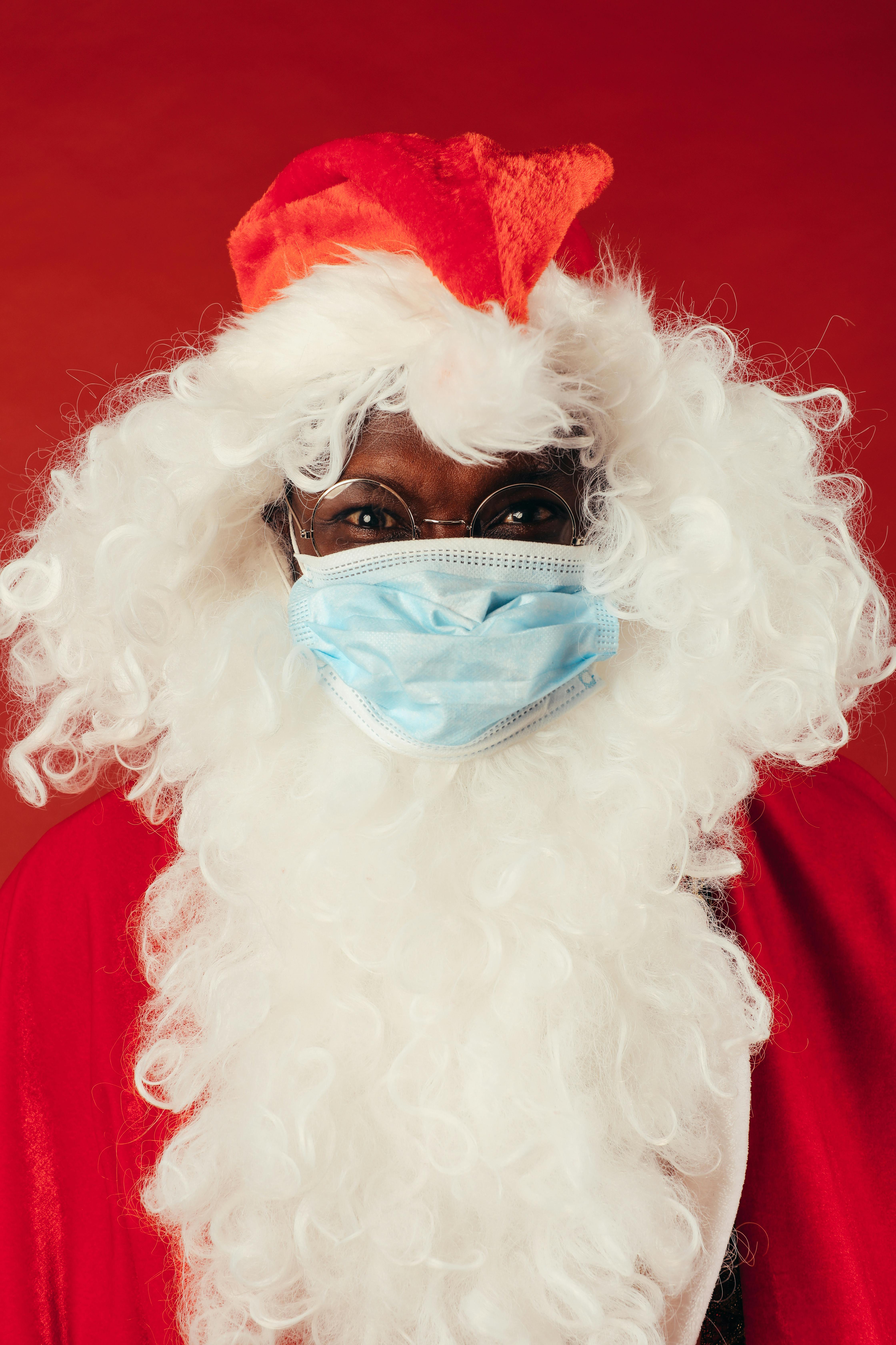 man in santa outfit with face mask