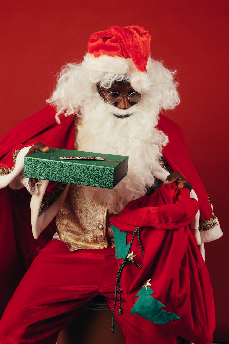 Santa Claus Holding Green Christmas Present