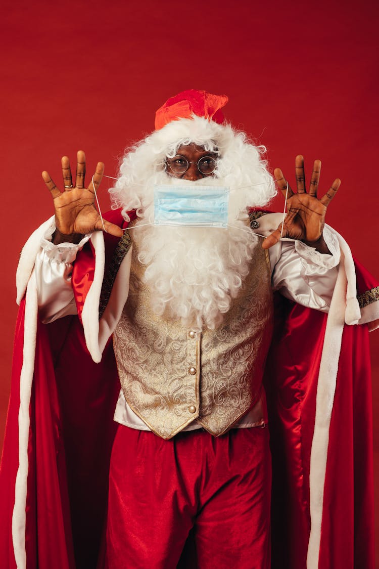 Santa Claus Holding A Face Mask