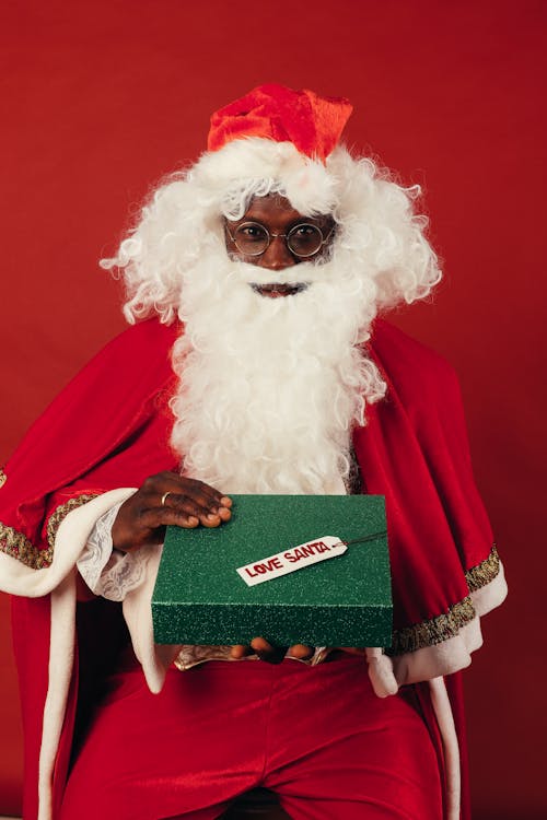 Santa Claus Holding Green Christmas Present