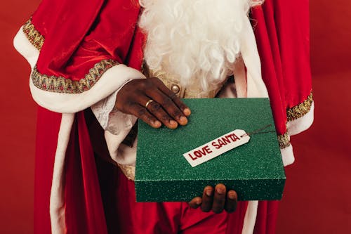 Person Holding Green Christmas Present