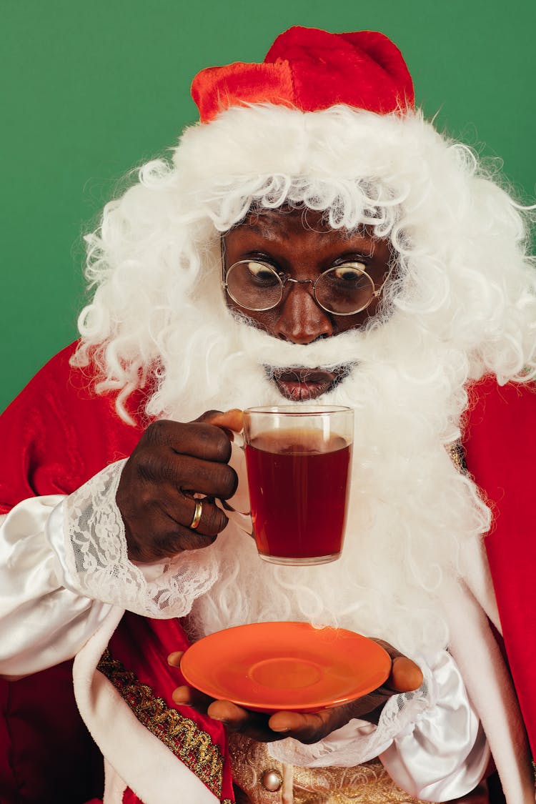 Man In Santa Outfit Drinking Hot Tea