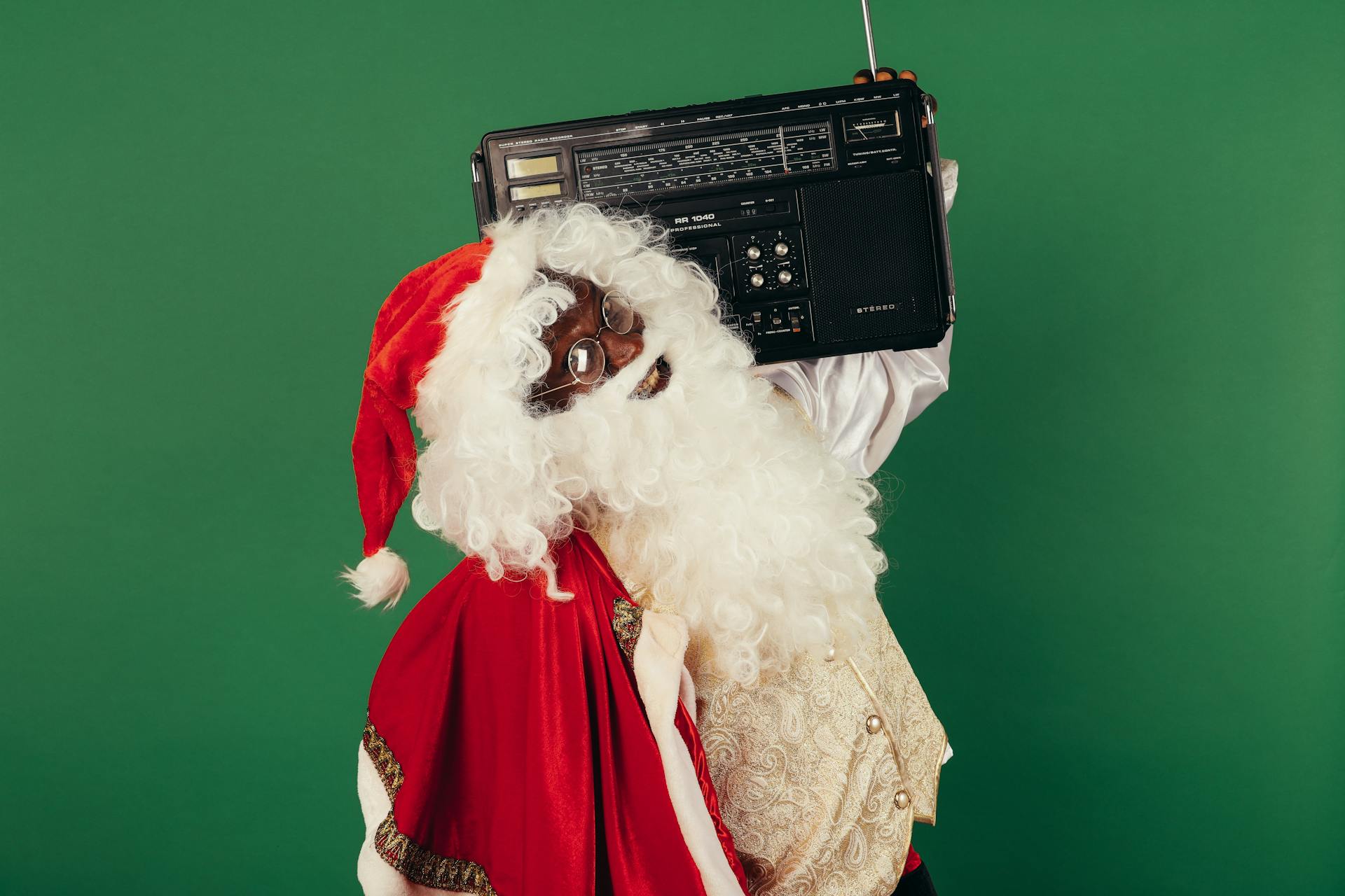 Santa Claus Holding A Classic Radio