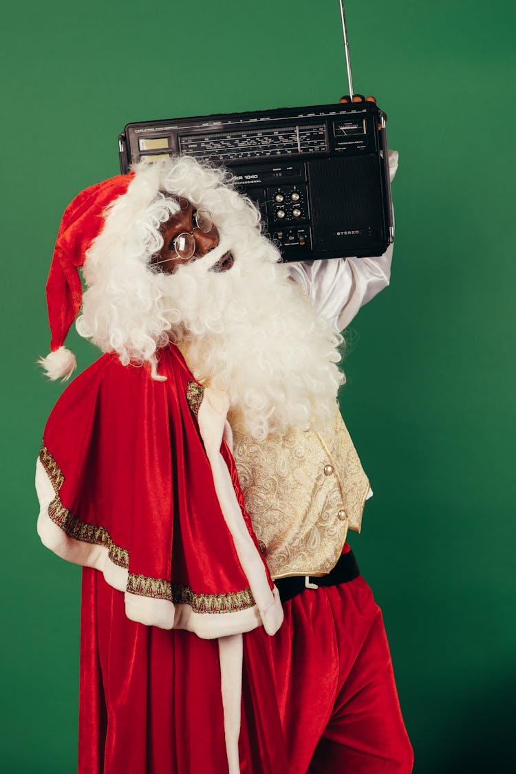 Santa Claus Carrying A Classic Radio 