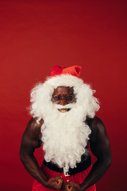 Man In Santa Outfit Flexing His Muscles