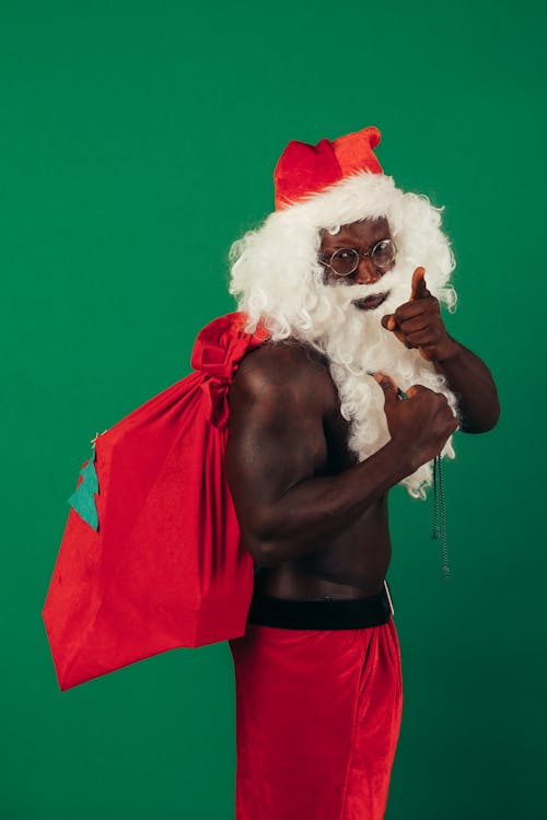 Free Man in Santa Claus Outfit Bringing Presents Stock Photo