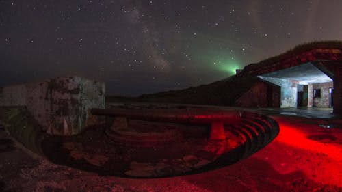 Concrete reservoir with metal pipe at night