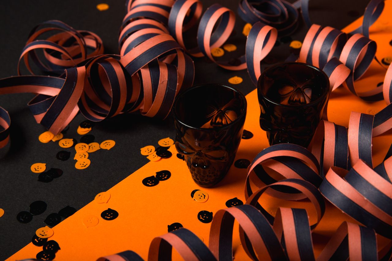 halloween themed decorations featuring skull shot glasses confetti and