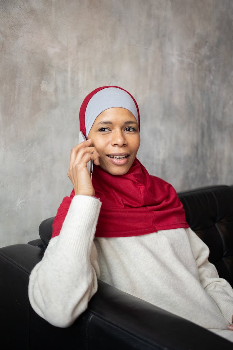 Happy Arabian Woman In Hijab Talking On Smartphone