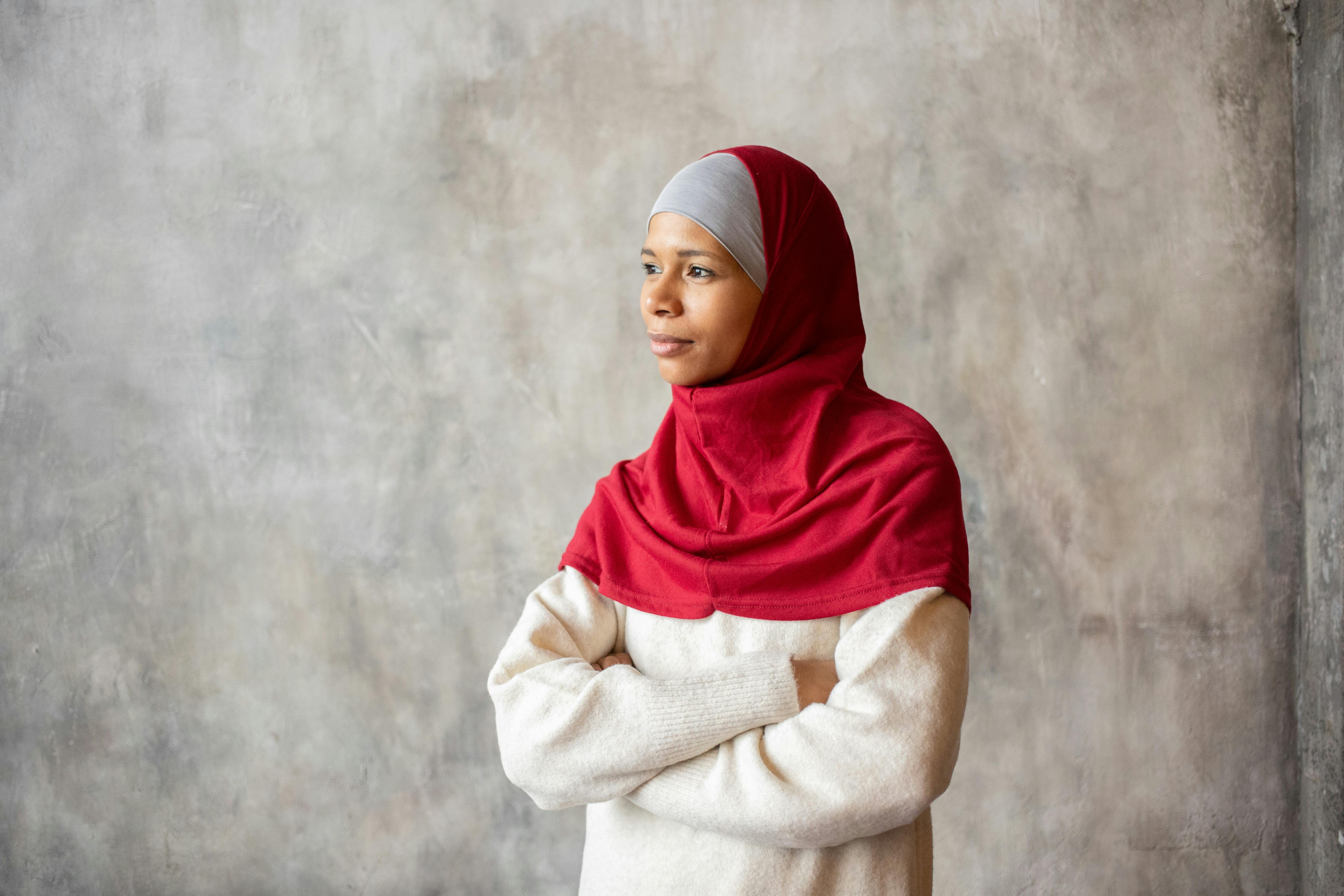 arabian muslim woman in red hijab with arms folded