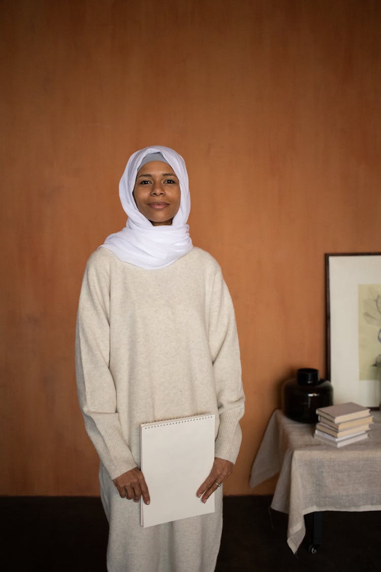 Happy Arabian Muslim Woman In Hijab With Notebook