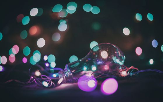 A mesmerizing bokeh effect with a light bulb surrounded by colorful lights, creating a dreamy atmosphere.