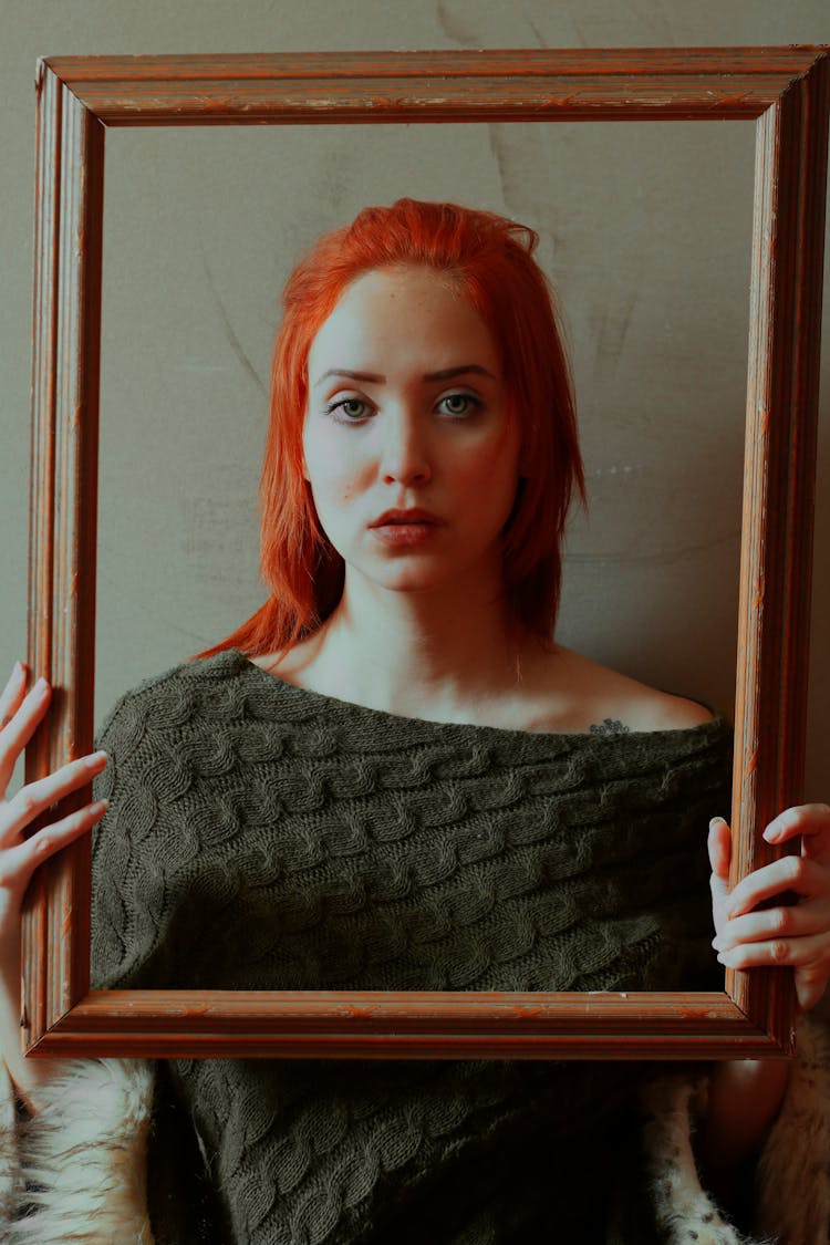 A Beautiful Woman Holding A Frame