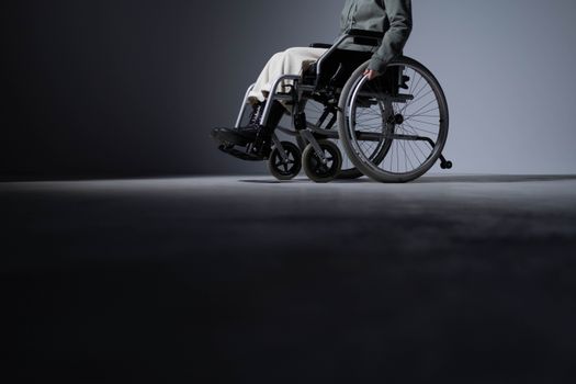 Studio shot of a person in a wheelchair with ample copy space, highlighting accessibility.