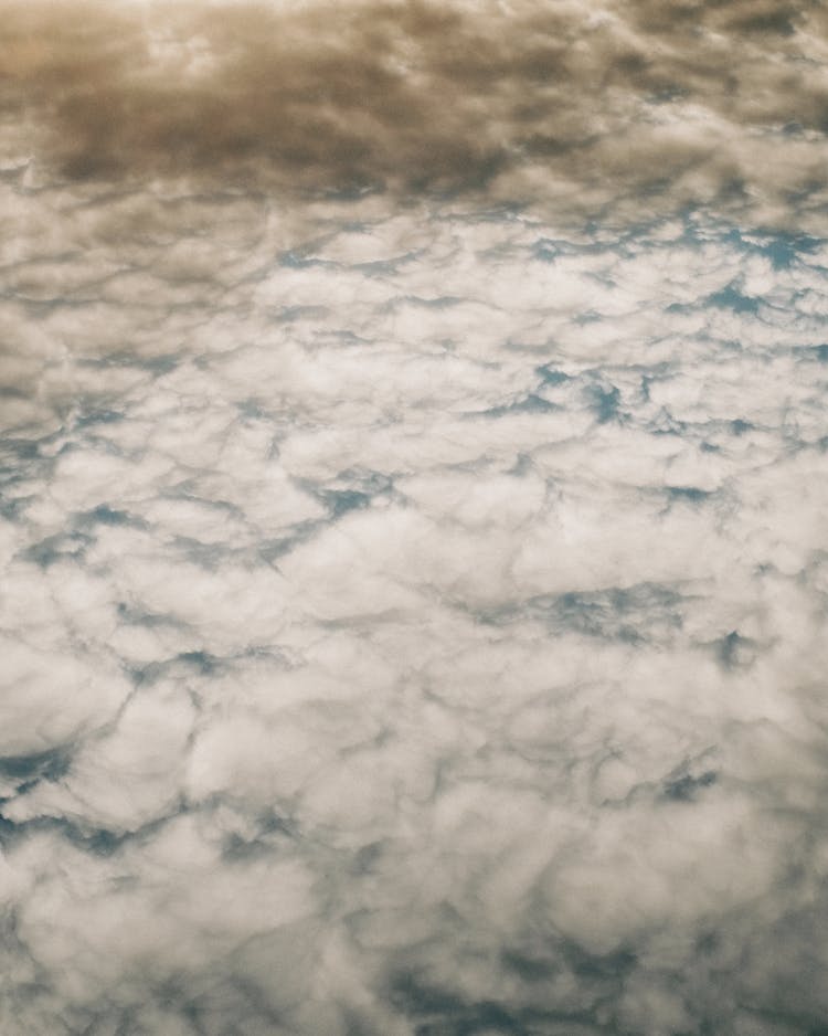 Clouds Illuminated By Sunlight Floating Above Ground