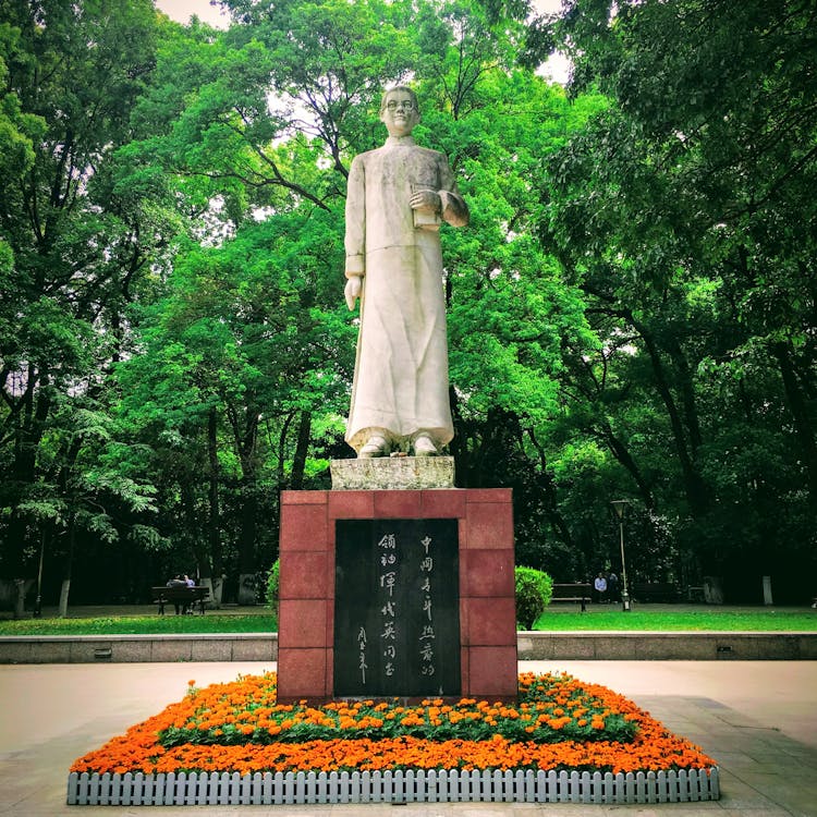 Concrete Statue Near Green Trees