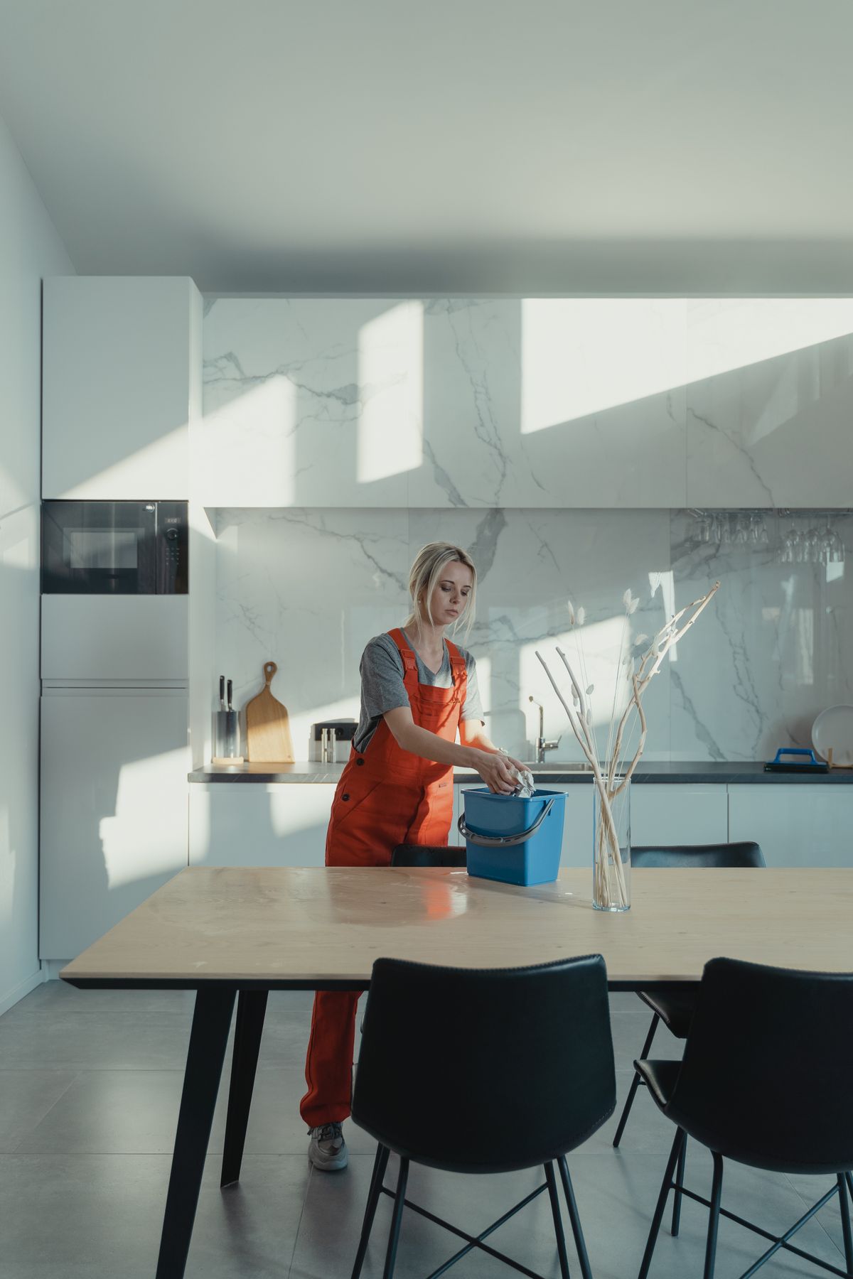 Professional cleaner caring for a modern kitchen