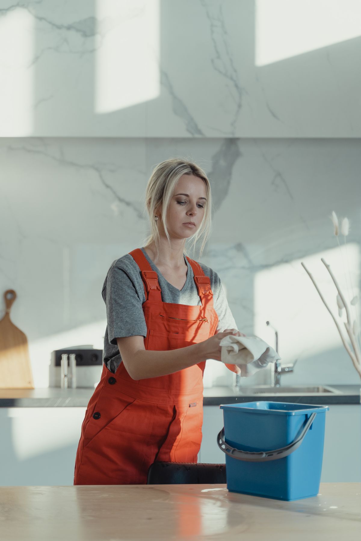 Professional housekeeper cleaning a kitchen counter