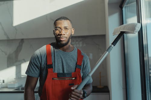 A Bearded man Holding a Cleaning Tool