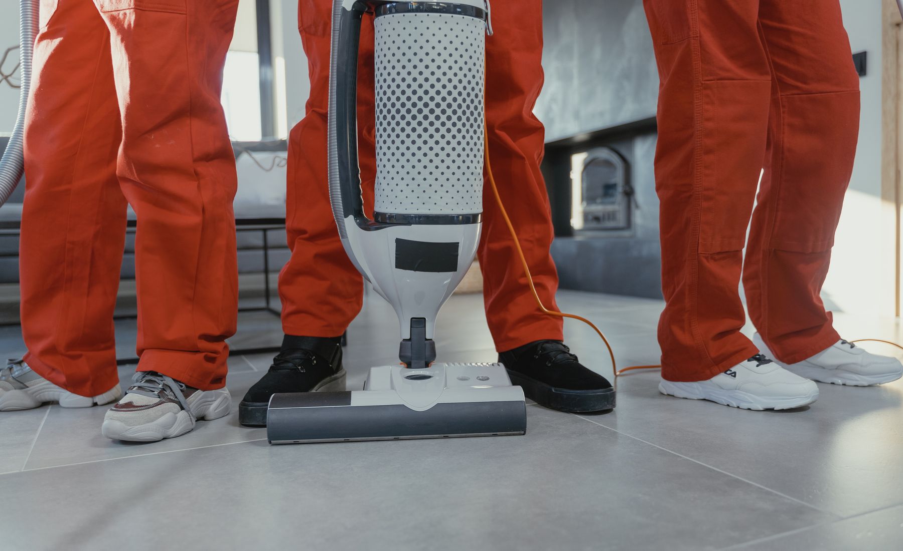 Professional cleaning crew at work in an office, wide shot
