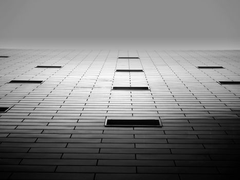 Dramatic perspective of a modern building facade in black and white.